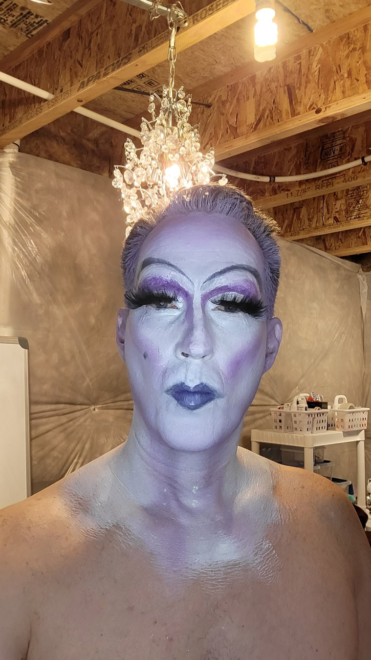 Maggie in purple-toned drag makeup